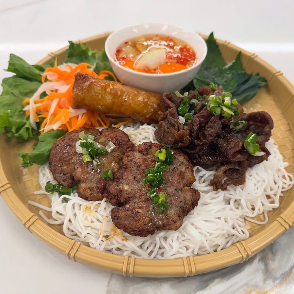 Mama Ha's Vietnamese vermicelli noodles with grilled pork, beef, spring roll, and dipping sauce.